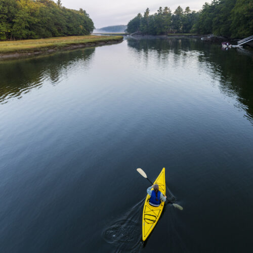 A kayaker enjoys an early morning paddle on the York River in York, Maine.