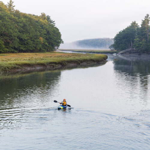 Two kayakers enjoy an early morning paddle on the York River in York, Maine.